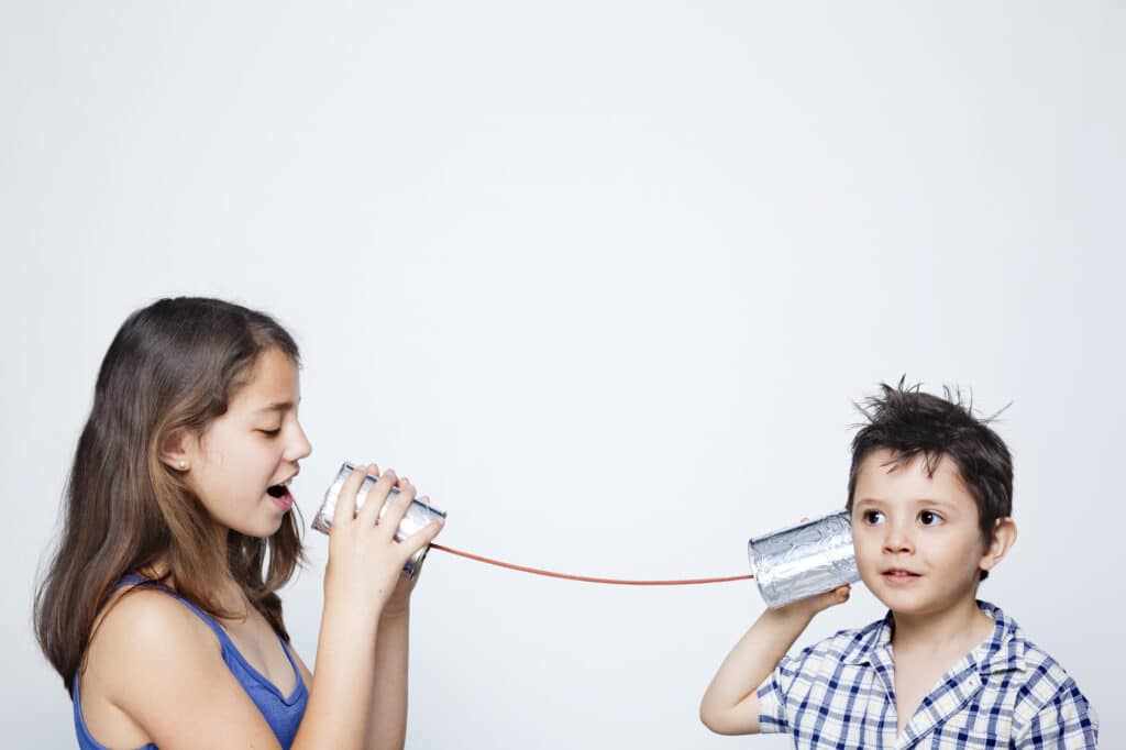 Julia Ngapo Business Coaching-Kids using a can as telephone against gray background - 5 digital marketing tips for professional practices