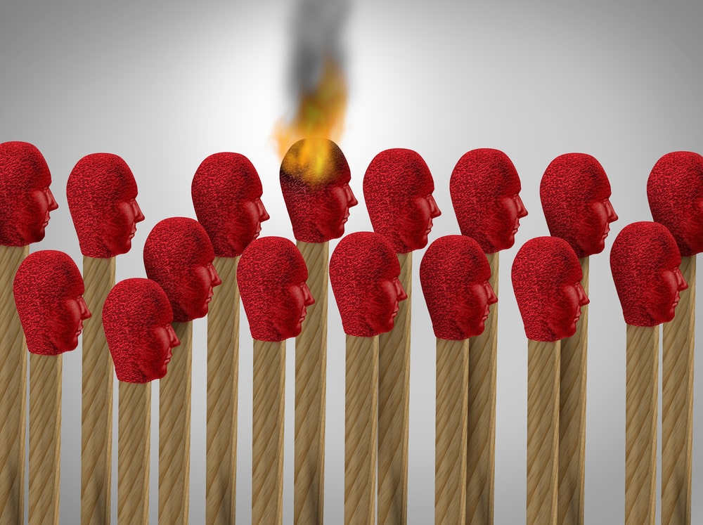 matches lined up with each matchhead shaped as a person's head. Spotting Signs of Team Burnout and 5 Strategies to Fight It